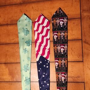 Three novelty holiday ties. One for Christmas, 4th of July, St Patrick's Day.